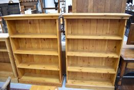 A pair of modern pine mid height bookshelves