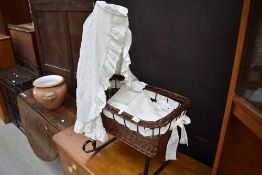 A reproduction wicker rocking crib