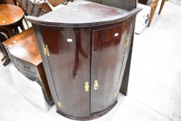A 19th Century mahogany bow front corner cupboard