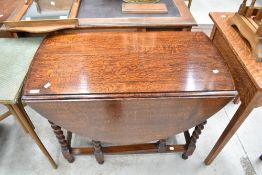 An early 20th Century oak gate leg dining table