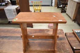 An Arts and Crafts 'Acorn Man' golden oak stool or side table with typical motif
