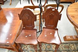 A pair of Victorian mahogany hall chairs