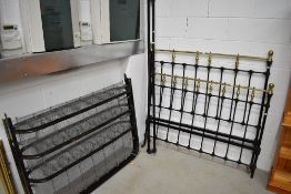 A Victorian cast and brass double bed frame and sprung base