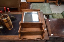 A late Victorian golden oak wall mirror with shelves under