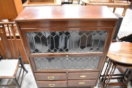 An early 20th Century mahogany stacking bookcase with cupboard base