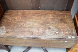 A 19th Century Regency design pedestal table having drop leaf top on turned column and quadruple