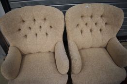 A pair of modern button back armchairs
