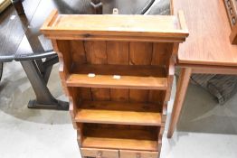 A modern narrow pine wall shelf