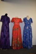 Three bright 1960s to 1970s maxi dresses.