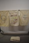 A selection of vintage feed sacks, some with lovely local advertisments on, others plain.