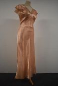 A 1940s Art Deco nightdress having lace detail to neckline, hem and fluted sleeves.