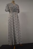 A 1930s floral day dress having press stud fastening to side, V neckline with smocking to