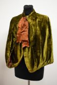 A Victorian moss green cape having brown quilted lining and bow to neckline, John Lewis Oxford