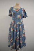 A late 1930s day dress in blue floral cotton having side metal zip, tiered skirt and square neckline