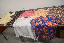 Seven vintage ladies tops and blouses in vibrant patterns, various sizes and styles.