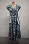 A Vintage 1950s day dress of floral cotton, having pockets to front and side metal zip.