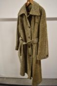A vintage Irish Tweed jacket having button front and belt to waist.