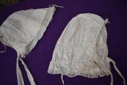 Two antique white cotton bonnets.