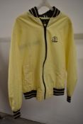 A 1984 yellow bomber style jacket in a lightweight yellow fabric, of Golfing interest, 113th opening