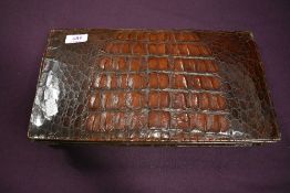 A large vintage Argentinean mahogany toned crocodile or similar clutch bag having internal pockets.