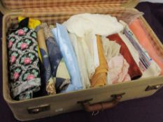 A suitcase full of mixed vintage and retro fabrics.