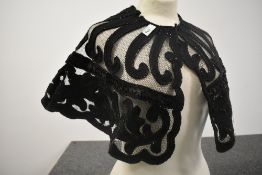 A Victorian beaded caplet with intricate detailing throughout.