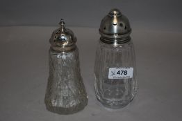 Two glass sugar casters having cut glass decoration and HM silver lids