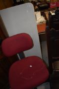 A plastic folding table and an office chair