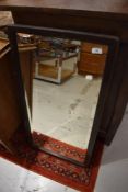 An early 20th Century oak wall mirror