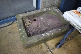 A shallow stone trough