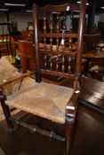 A 19th Century rush seated spindle back carver chair