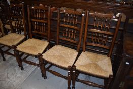 A set of four reproduction rush seated spindle back chairs