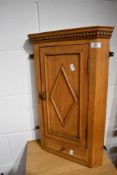 A Victorian stripped small corner cabinet