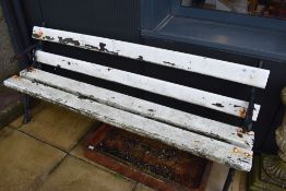 A 19th Century garden bench having naturalistic cast iron ends