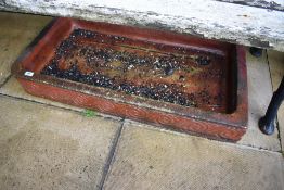 A glazed shallow trough