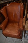 A modern brown leather armchair