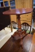 A stained frame pedestal table