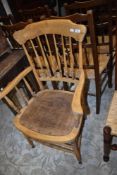 A Victorian stripped spindle back armchair