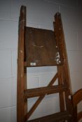 A large set of wooden stepladders