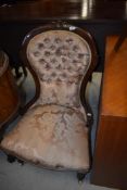 A Victorian nursing chair having shaped back