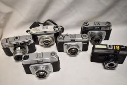 Six Cameras. Two Ilford Sportsman, a Dacona Dignette, a Baldo Baldixette, a Halina Paulette, and a