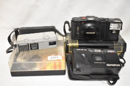 Three cameras. An Olympus AII and Olympus Trip AAF Mini and a Minolta 16 EE