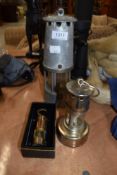Three decorative miners lamps of varying sizes.