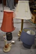 Four bedside lamps of various designs and sizes.