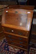 A reproduction yew wood bureau