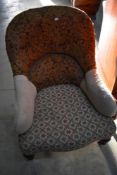 A Victorian spoon back easy chair