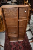 An Ercol mid stain wall shelf, width approx. 107cm