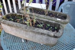 Two concrete troughs and contents