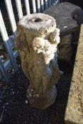 A vintage style concrete birdbath stand