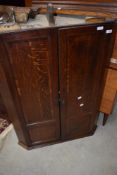 A 19th Century oak corner cupboard having panelled doors
